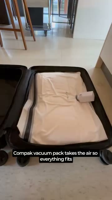 Tilliv Compak vacuum pack compressed inside an open carry-on suitcase